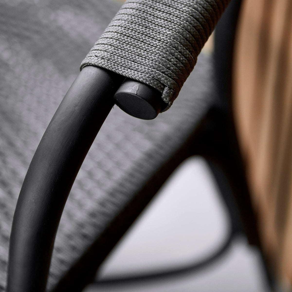 Noble Indoor Armchair by Cane-Line, showing closeup view of noble indoor armchair in live shot.