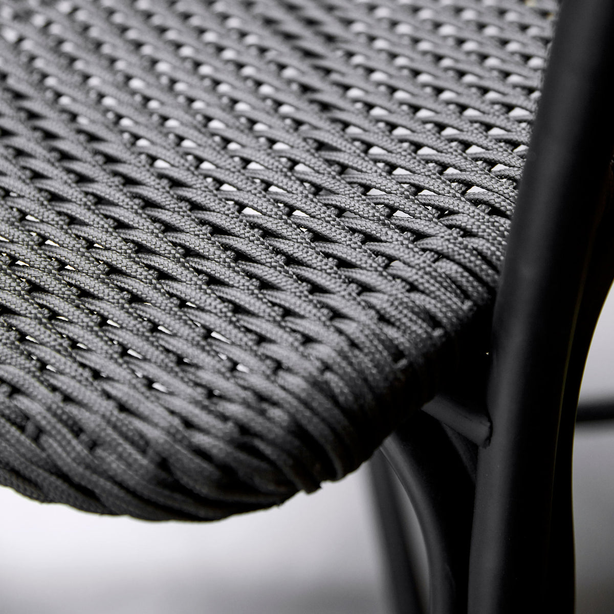 Noble Indoor Armchair by Cane-Line, showing closeup view of noble indoor armchair in live shot.