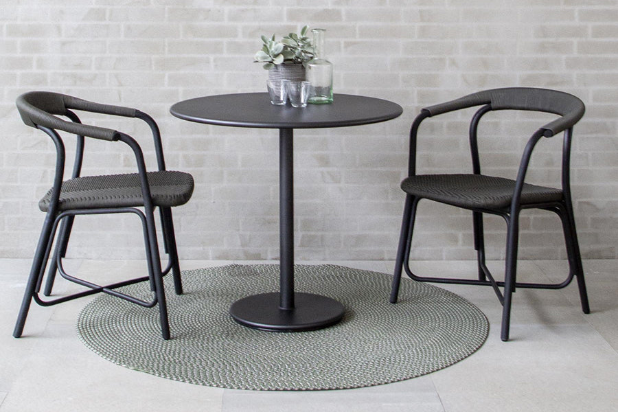 Noble Indoor Armchair by Cane-Line, showing noble indoor armchairs with table in live shot.