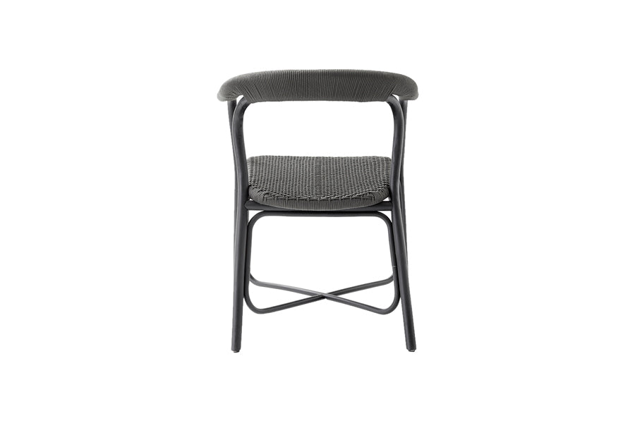 Noble Indoor Armchair by Cane-Line, showing back view of noble indoor arm chair in black rattan/aluminum.