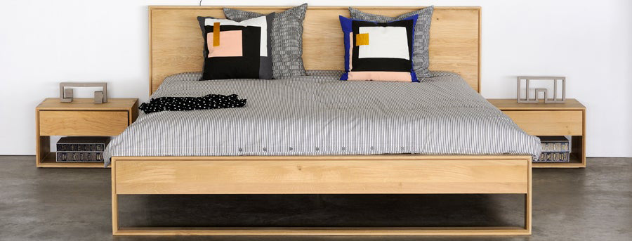 Nordic ll Nightstand by Ethnicraft, showing nordic ii oak nighstands with bed in live shot.