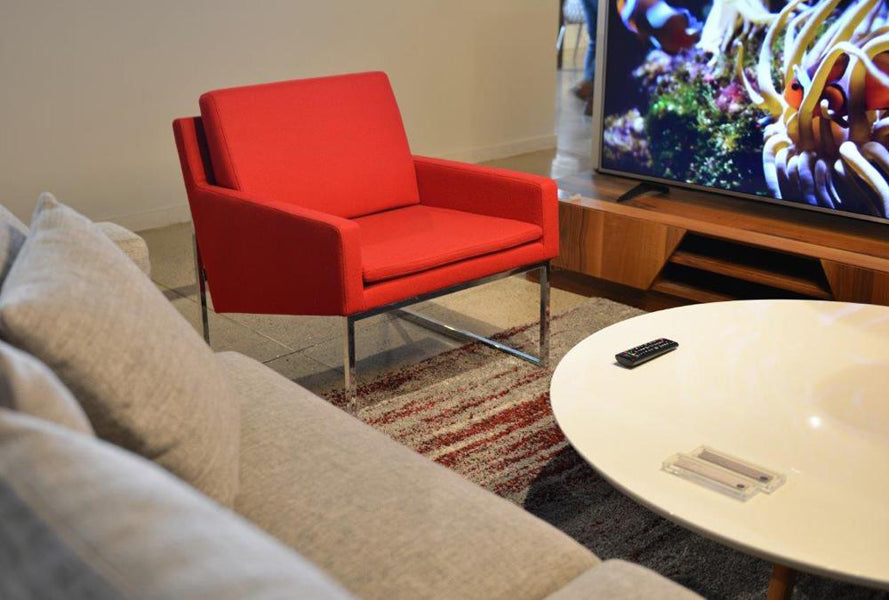 Nova Sled Armchair by SohoConcept, showing nova sled armchair with table in live shot.