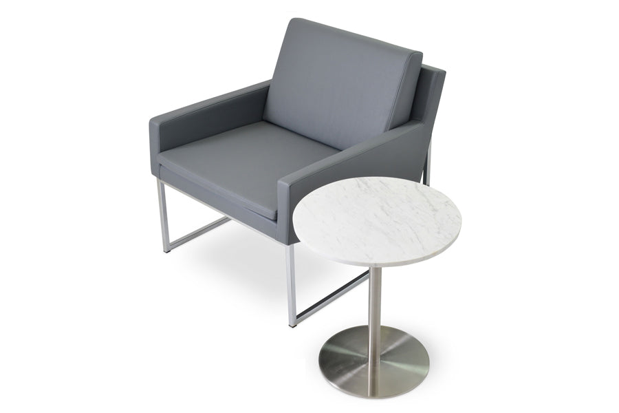 Nova Sled Armchair by SohoConcept, showing nova sled armchair with table.