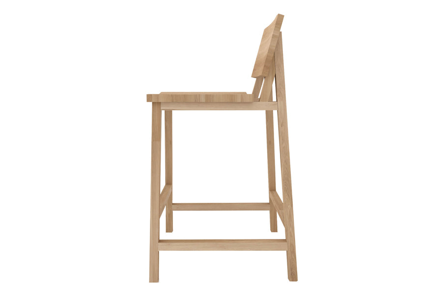 N3 Counter Stool by Ethnicraft, showing side view of n3 kitchen counter stool in oak.