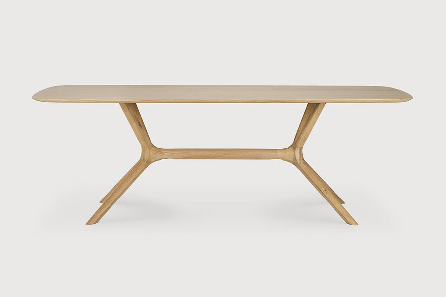 X Dining Table by Ethnicraft, showing front view of oak x dining table in oak wood.