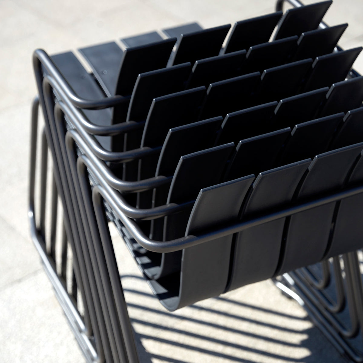 Ocean Dining Chair by Mater, showing closeup view of ocean dining chairs in live shot.