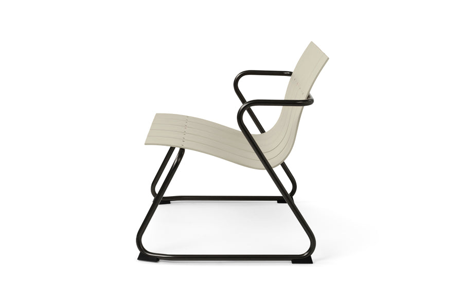 Ocean Lounge Chair by Mater, showing side view of ocean lounge chair in sand plastic seat.