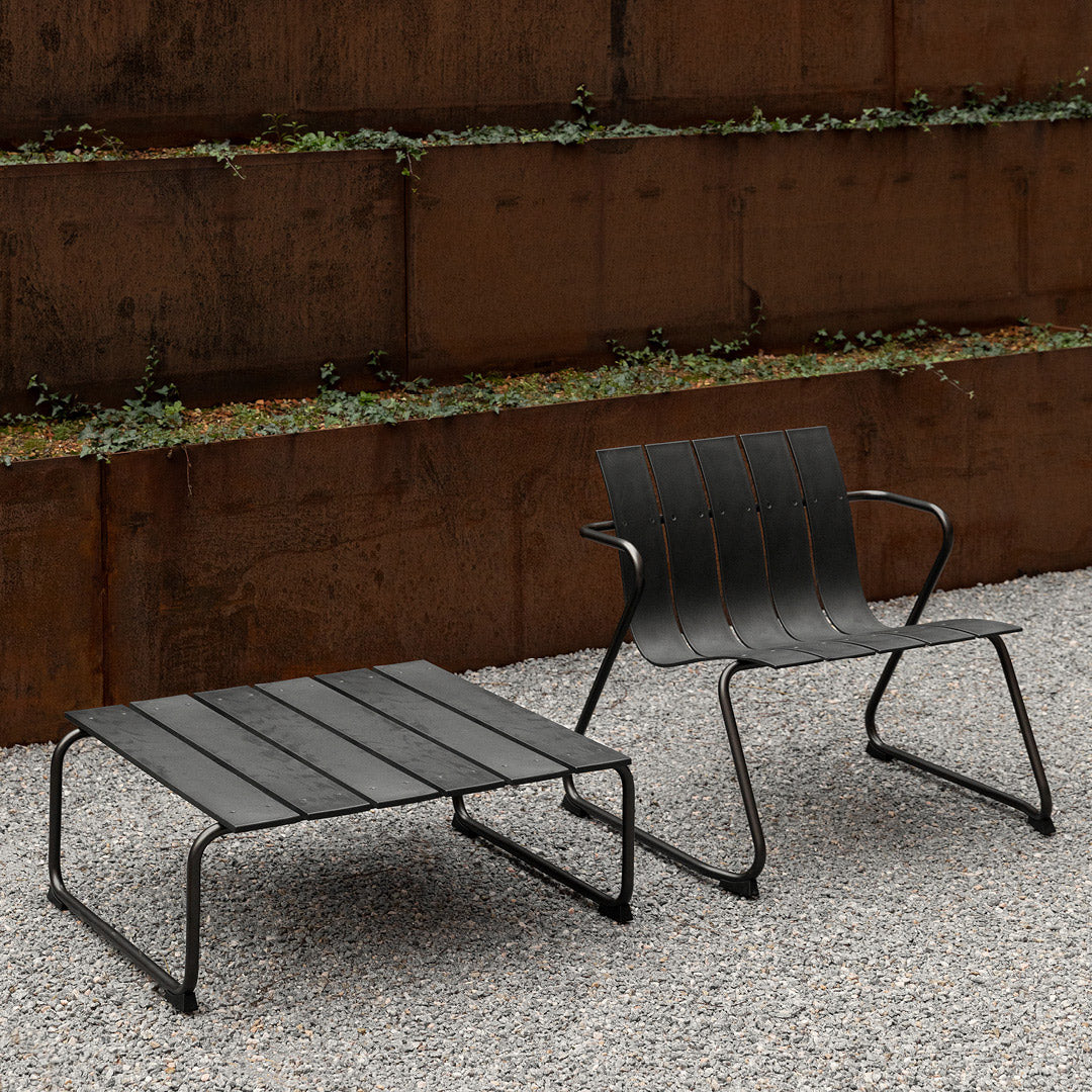 Ocean Lounge Table by Mater, showing ocean lounge table with chair in live shot.