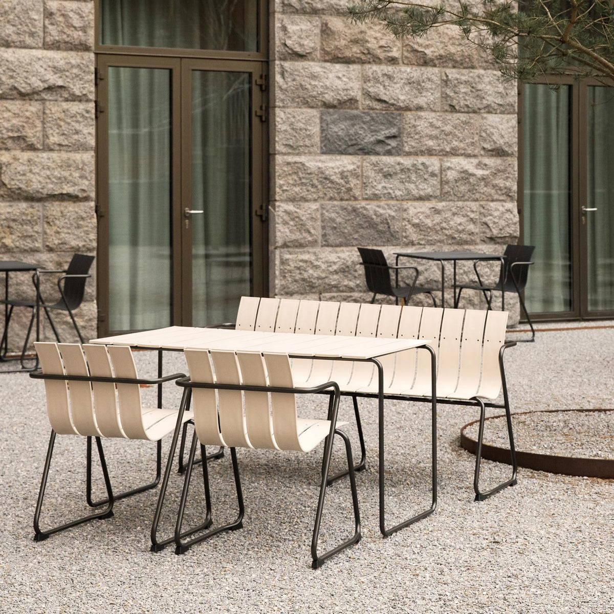 Ocean Table by Mater, showing ocean table with chairs in live shot.