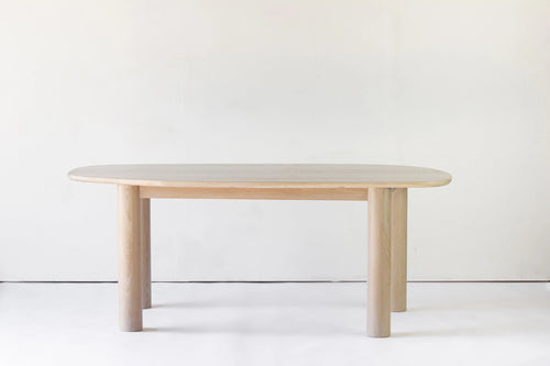 Ohm Dining Table by Sun at Six, showing front view of ohm dining table in studio shot.