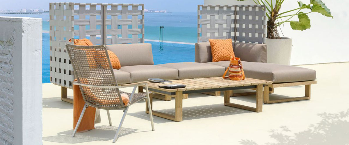 Olaf Easy Armchair by Mamagreen, showing olaf easy armchair with sectional & table in live shot.