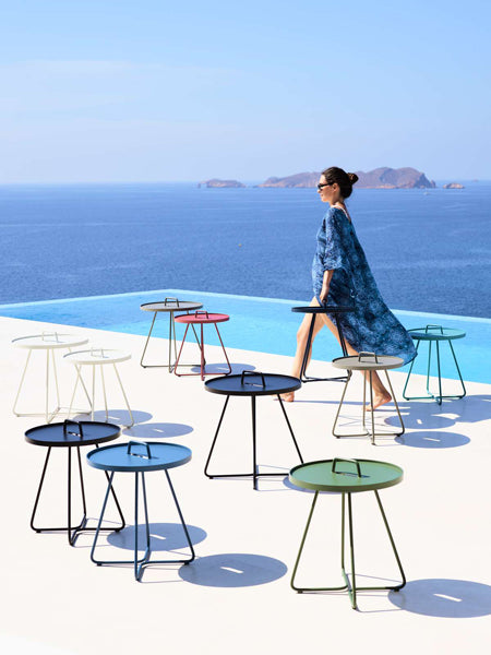 On The Move Side Table by Cane-Line, showing on the move side tables in live shot.