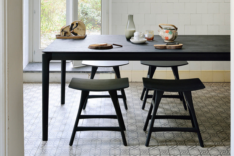 Osso Dining Stool by Ethnicraft, showing osso dining stools with table in live shot.