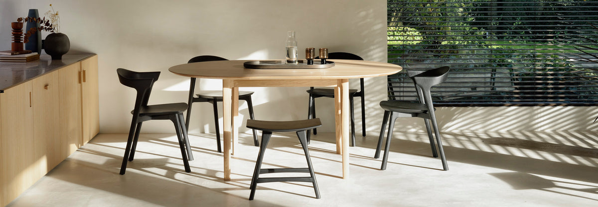 Osso Dining Stool by Ethnicraft, showing osso dining stool with chairs & table in live shot.