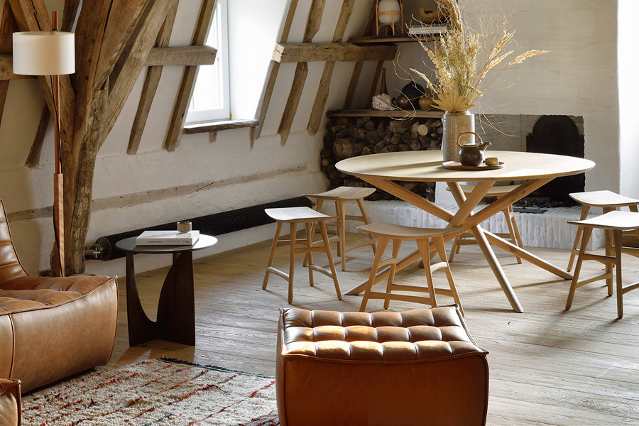 Osso Dining Stool by Ethnicraft, showing osso dining stools with table in live shot.
