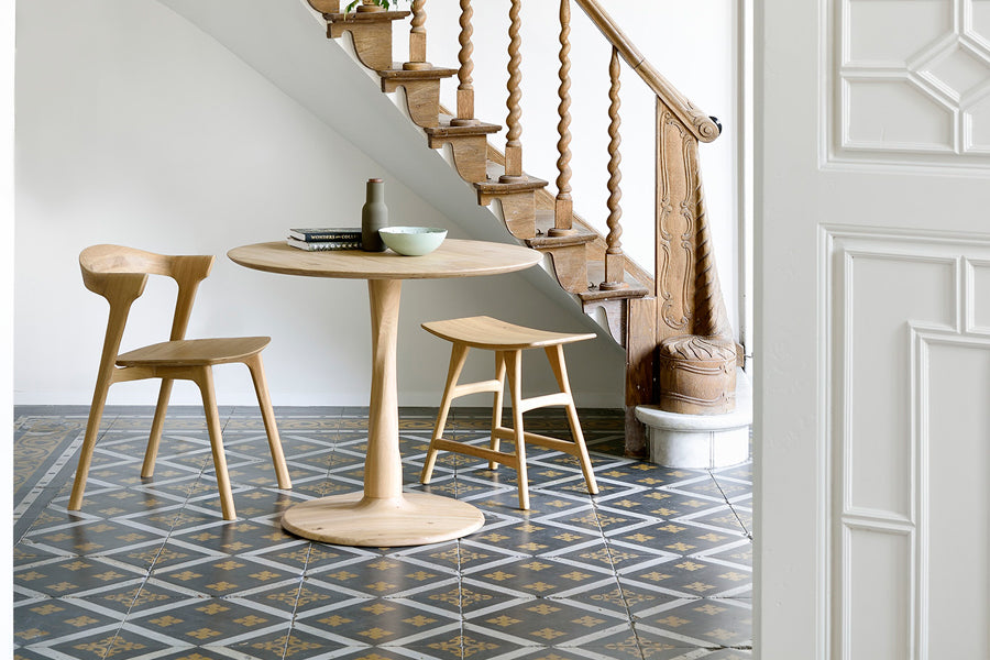 Osso Dining Stool by Ethnicraft, showing osso dining stool with chair & table in live shot.
