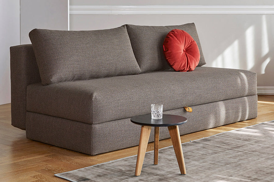 Osvald Sofa Bed by Innovation, showing osvald sofa bed with table in live shot.