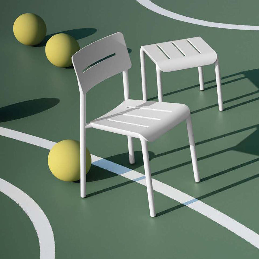Outo Hocker Side Table by Toou, showing outo hocker side table with chair in live shot.