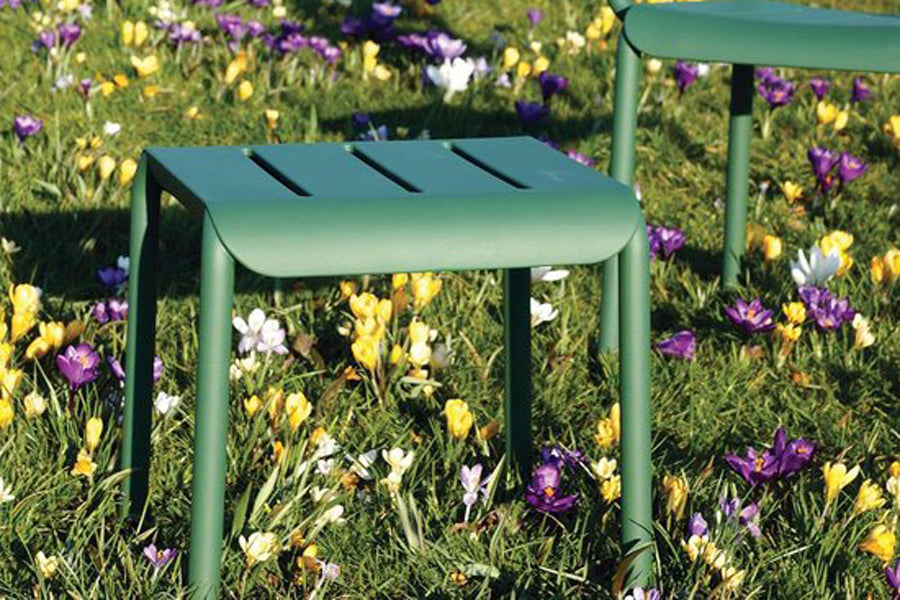Outo Hocker Side Table by Toou, showing outo hocker side table with chair in live shot.