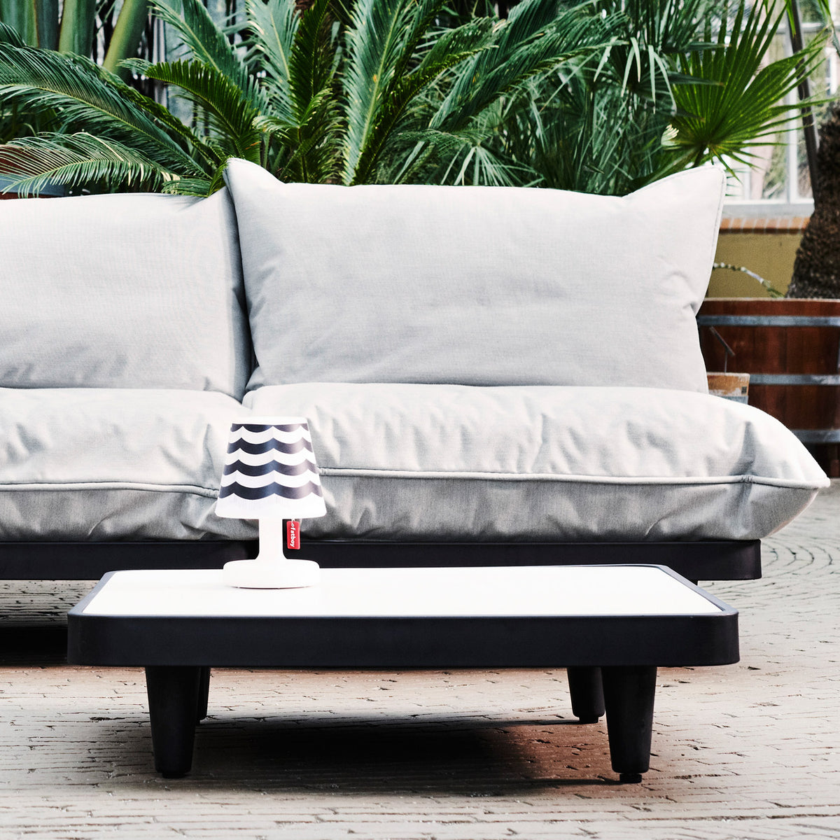 Paletti Outdoor Coffee Table by Fatboy, showing paletti outdoor coffee table in live shot.