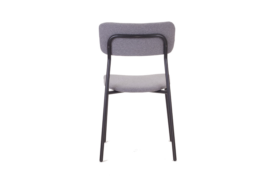 Paloma Dining Chair by Kollektiff, showing back view of paloma dining chair in gray fabric upholstered seat & backrest + black metal frame.
