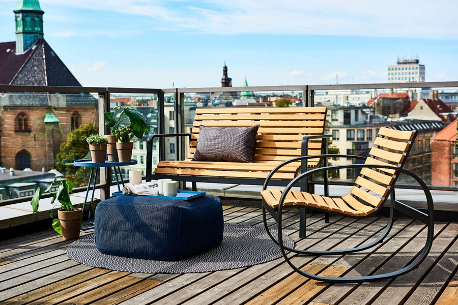 Parc Rocking Chair by Cane-Line, showing parc rocking chair with bench & table in live shot.