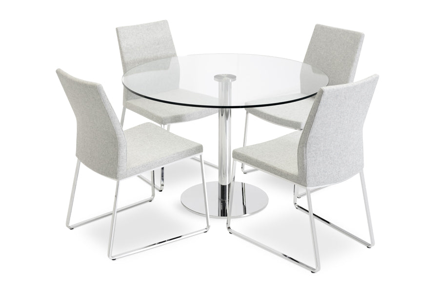 Pasha Sled Dining Chair by sohoConcept, showing front view of the table with chairs.
