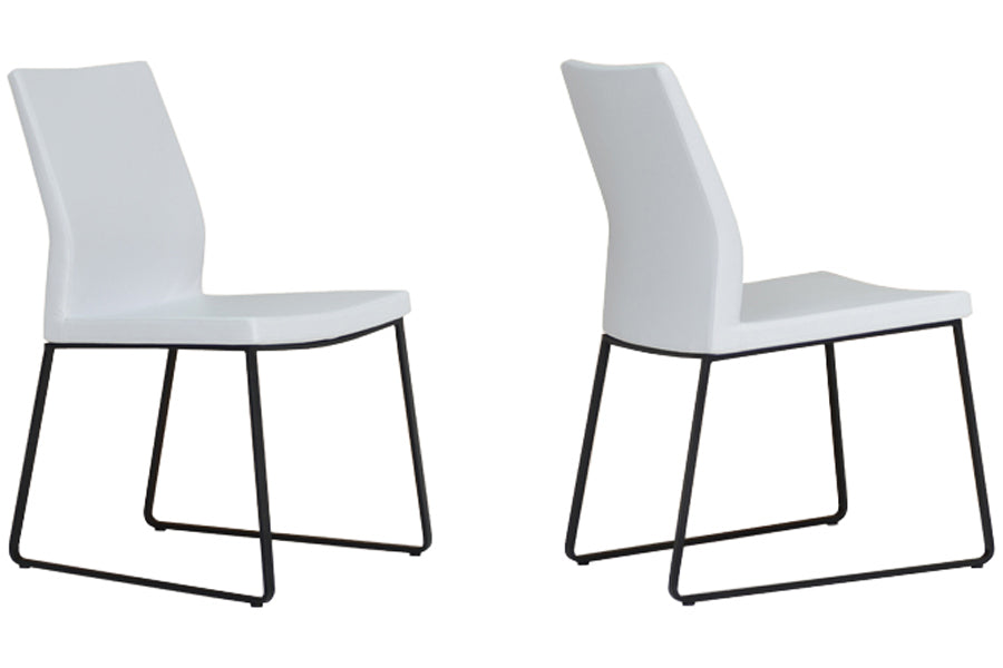 Pasha Sled Dining Chair by SohoConcept, shown in white leatherette with black powder coated steel tubes base.