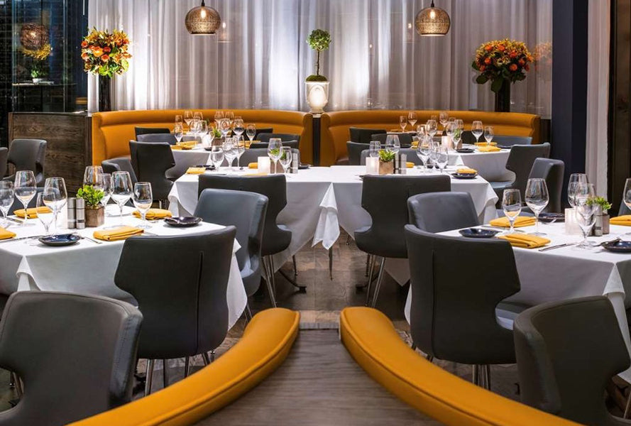 Patara Metal Dining Chair by SohoConcept, showing metal dining chairs with table in live shot.