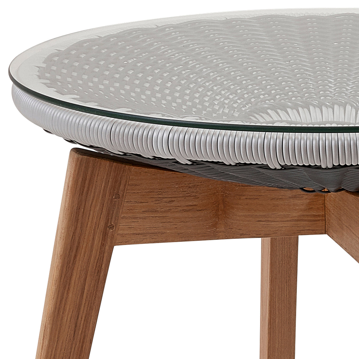 Peacock Footstool/Side Table by Cane-Line, showing closeup view of peacock footstool/side table in grey/light grey, clear safety glass.