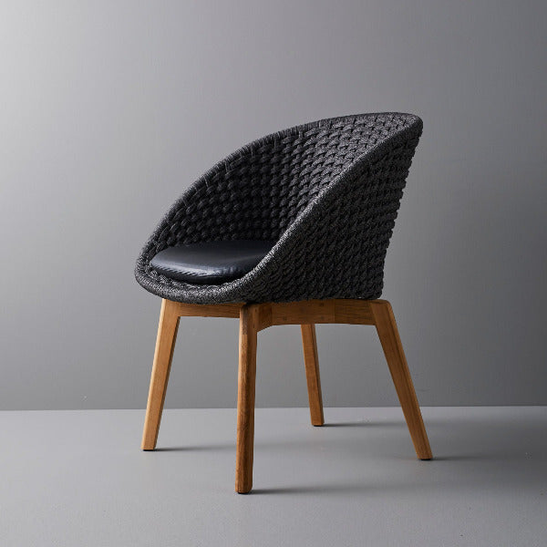 Peacock Indoor Dining Chair by Cane-Line, showing peacock indoor dining chair in live shot.