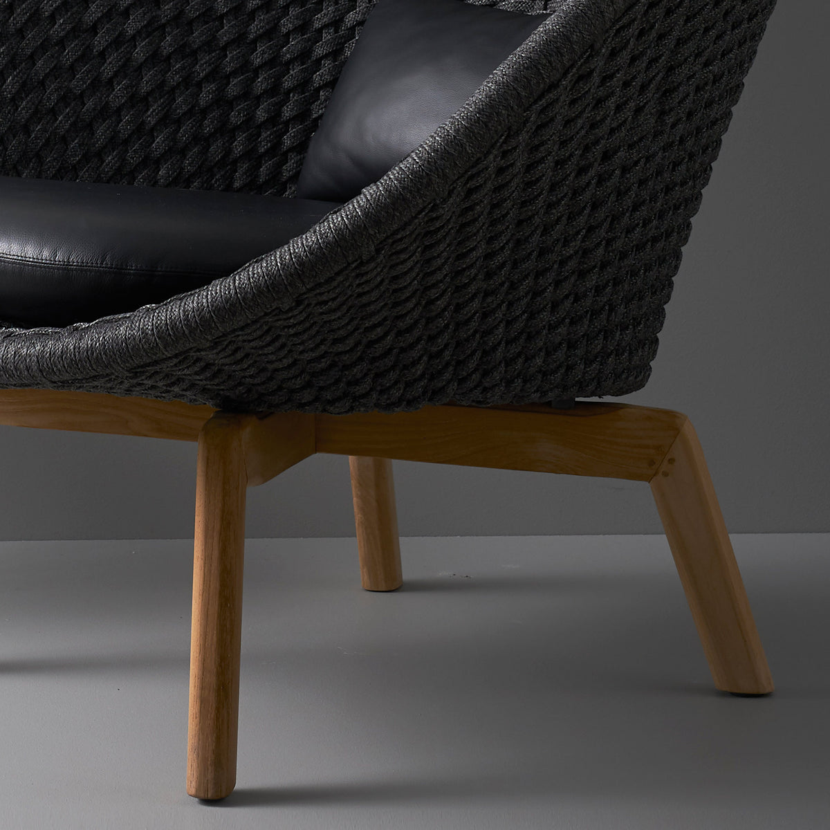 Peacock Indoor Lounge Chair by Cane-Line, showing closeup view of peacock indoor lounge chair in live shot.