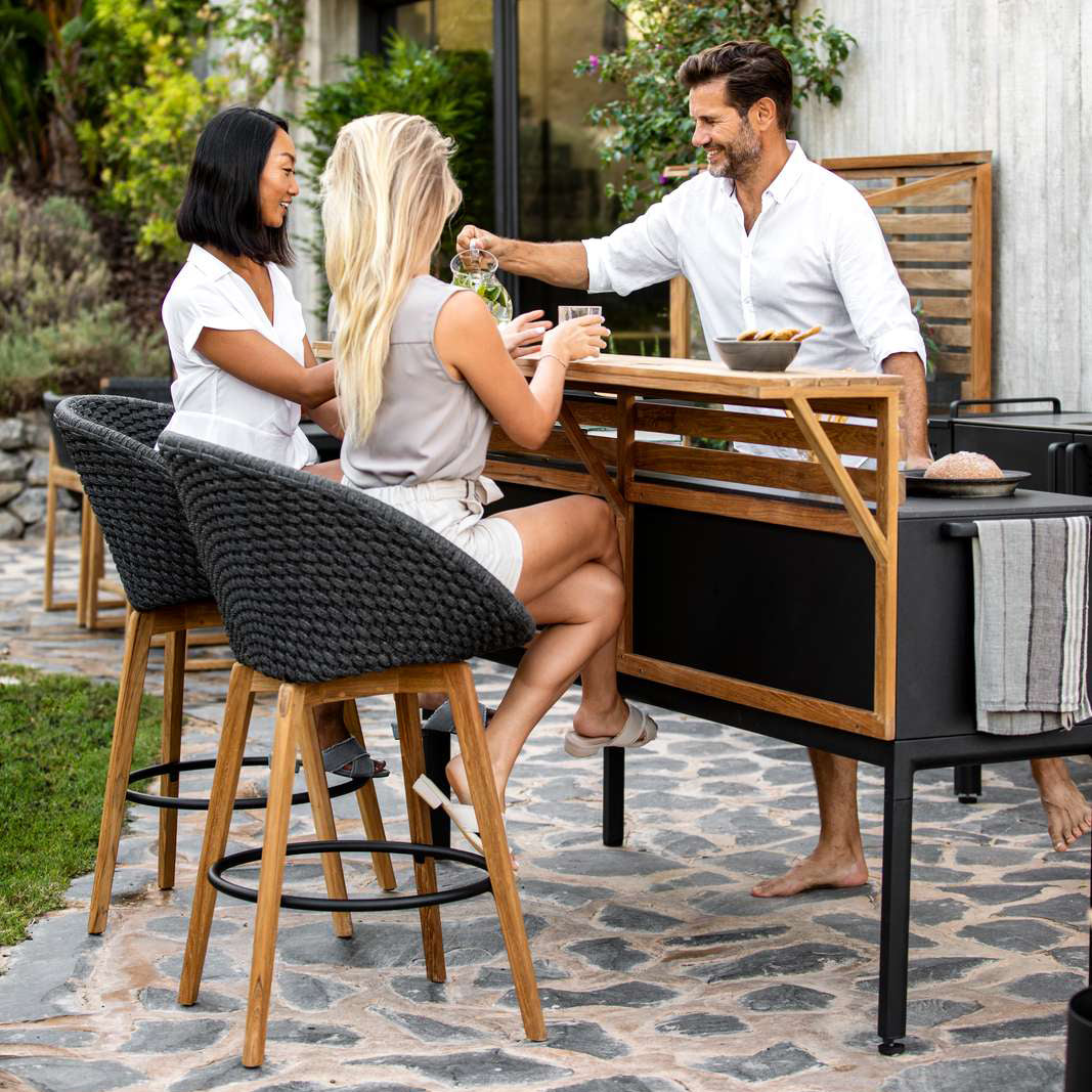 Peacock Outdoor Bar Chair with Teak Legs by Cane-Line, showing peacock outdoor bar chairs in live shot.