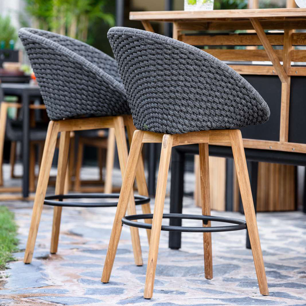 Peacock Outdoor Bar Chair with Teak Legs by Cane-Line, showing peacock outdoor bar chairs in live shot.