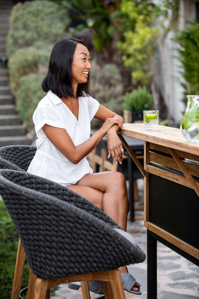 Peacock Outdoor Bar Chair with Teak Legs by Cane-Line, showing peacock outdoor bar chairs in live shot.