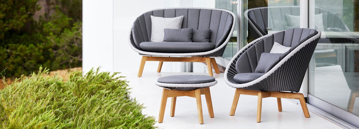 Peacock Outdoor 2-Seater Sofa by Cane-Line, showing peacock outdoor 2-seater sofa in live shot.