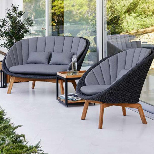 Peacock Outdoor 2-Seater Sofa by Cane-Line, showing peacock outdoor 2-seater sofa in live shot.