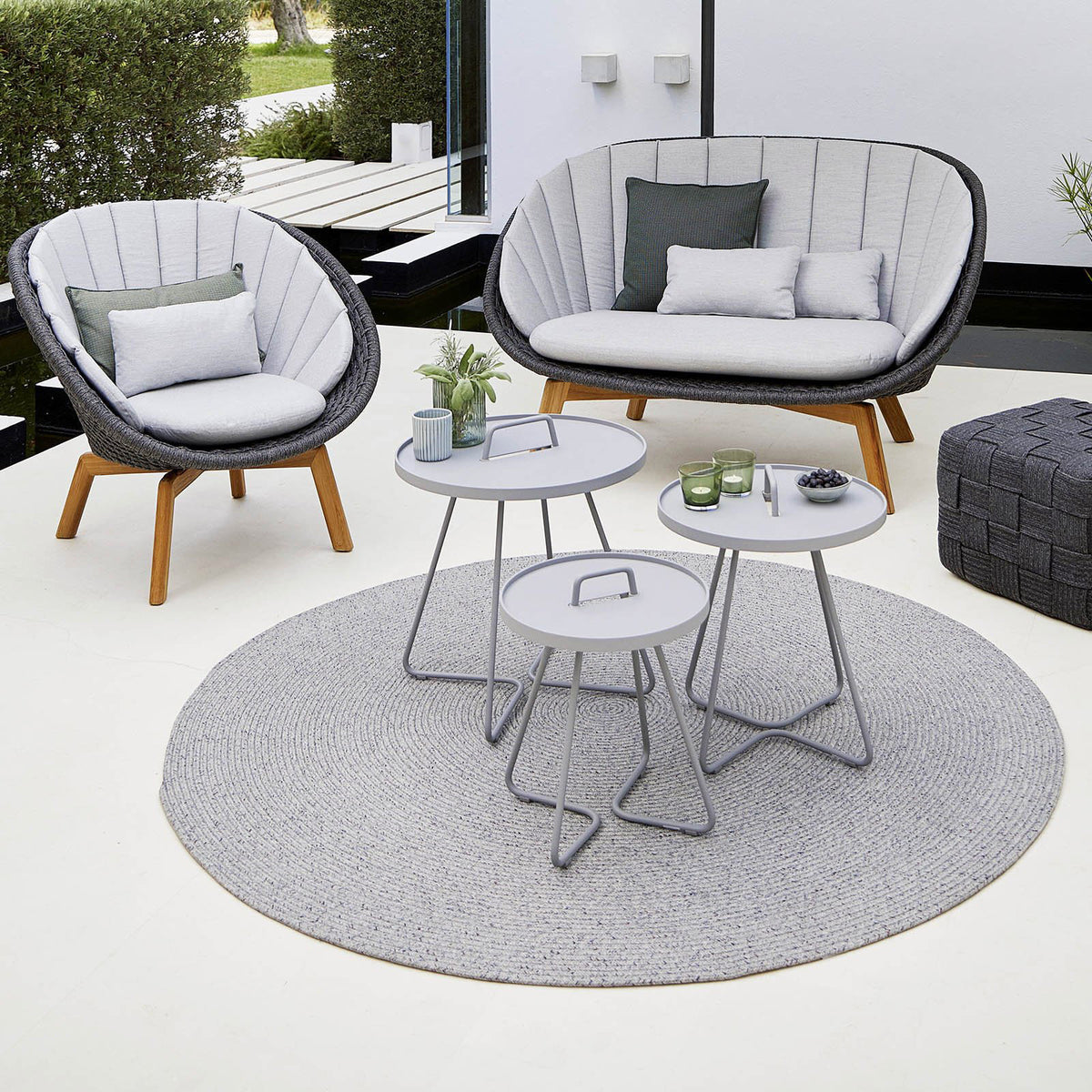 Peacock Outdoor 2-Seater Sofa by Cane-Line, showing peacock outdoor 2-seater sofa in live shot.