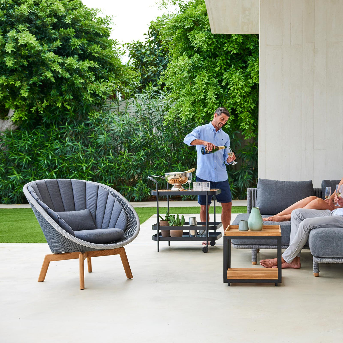 Peacock Outdoor Lounge Chair by Cane-Line, showing peacock outdoor lounge chair in live shot.