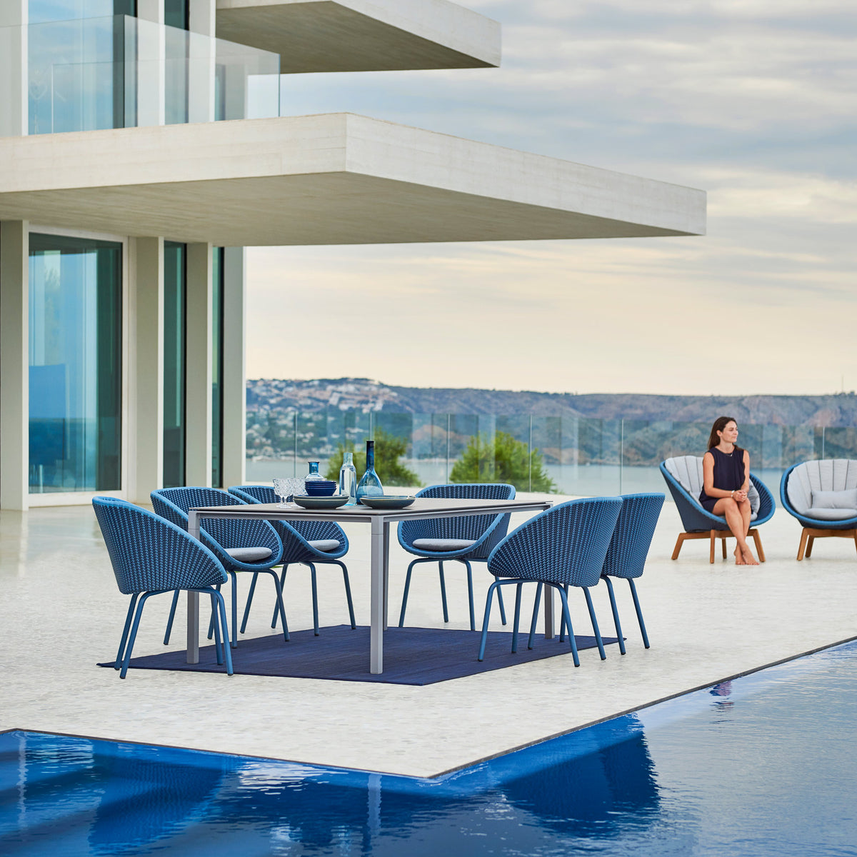 Peacock Outdoor Lounge Chair by Cane-Line, showing peacock outdoor lounge chairs in live shot.
