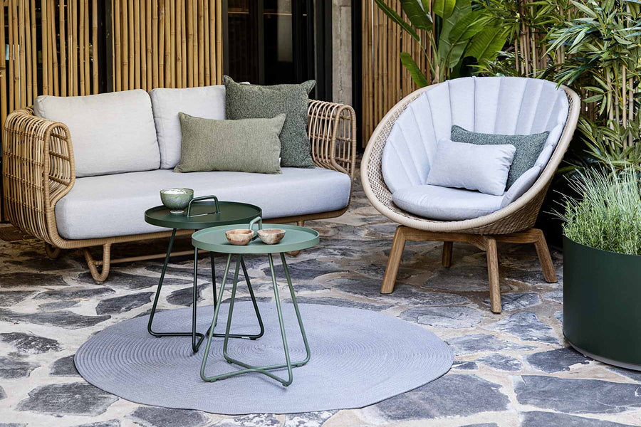 Peacock Outdoor Lounge Chair by Cane-Line, showing peacock outdoor lounge chair in live shot.