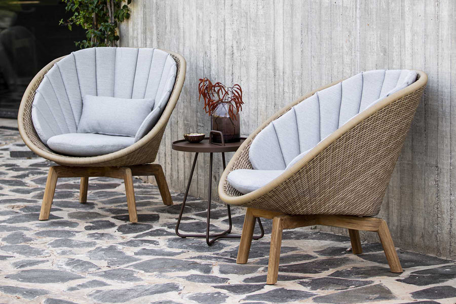 Peacock Outdoor Lounge Chair by Cane-Line, showing peacock outdoor lounge chairs in live shot.