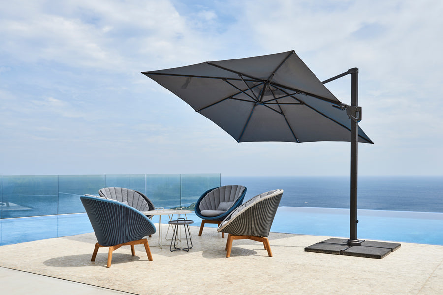 Peacock Outdoor Lounge Chair by Cane-Line, showing peacock outdoor lounge chairs in live shot.