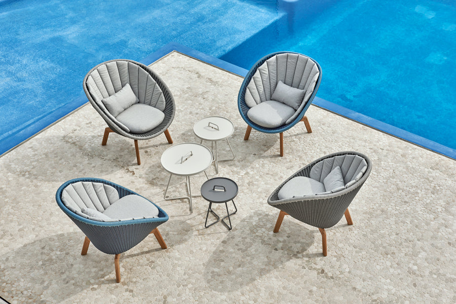 Peacock Outdoor Lounge Chair by Cane-Line, showing peacock outdoor lounge chairs in live shot.