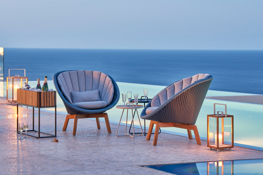 Peacock Outdoor Lounge Chair by Cane-Line, showing peacock outdoor lounge chairs in live shot.