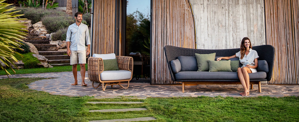 Peacock Wing 3 Seater Sofa with Teak Legs by Cane-Line, showing peacock wing 3 seater sofa with teak legs in live shot.