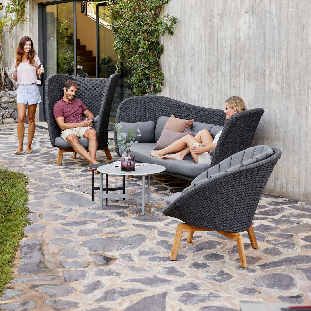 Peacock Wing 3 Seater Sofa with Teak Legs by Cane-Line, showing peacock wing 3 seater sofa with teak legs in live shot.