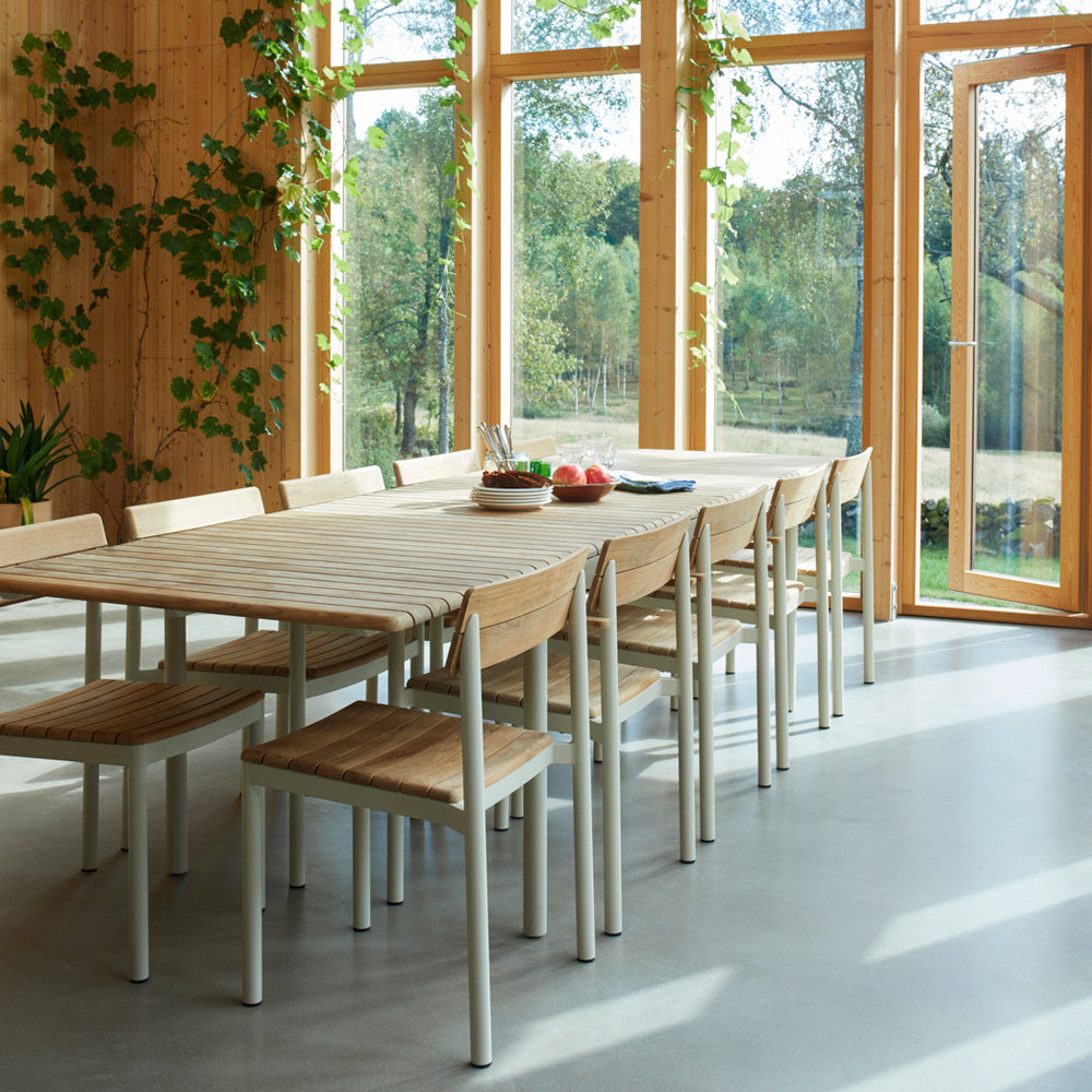 Pelago Dining Table by Skagerak, showing closeup view of pelago dining table with chairs in live shot.