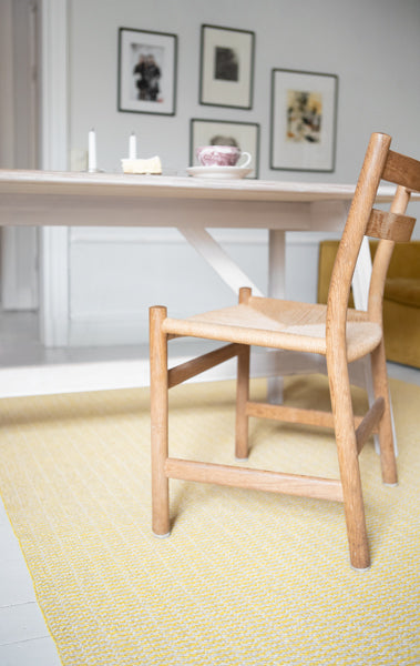 Pemba Woven Plastic Rug by Brita, showing closeup view of pemba woven plastic rug in live shot.