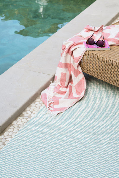 Pemba Woven Plastic Rug by Brita, showing closeup view of pemba woven plastic rug in live shot.